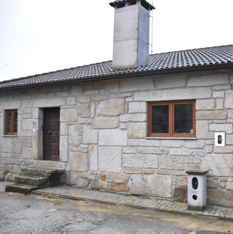 a stone house with a chimney on top of it at Casa do Tavares in Carvalhais