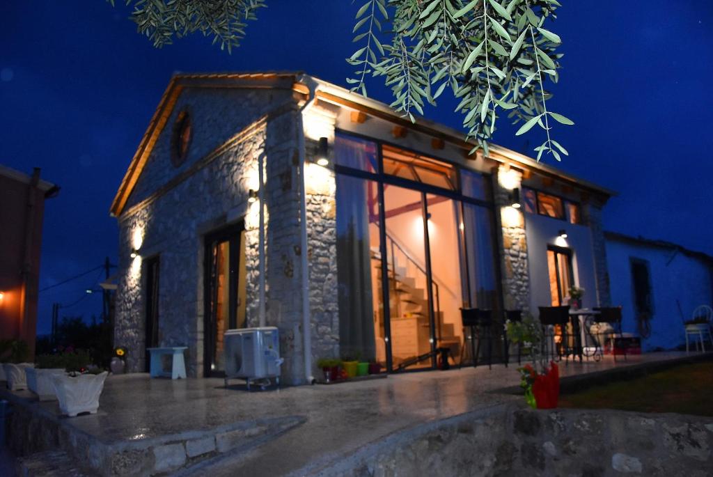 a stone house with lights on it at night at Casa Pietra in Kontokali