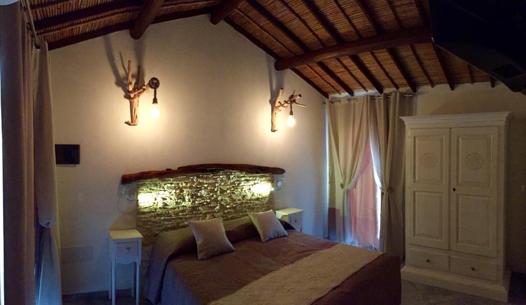 a bedroom with a bed with lights on the wall at Acquamaris Tuerredda in Campionna