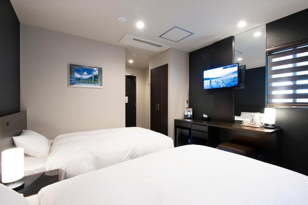 Postel nebo postele na pokoji v ubytování Hotel Kojan