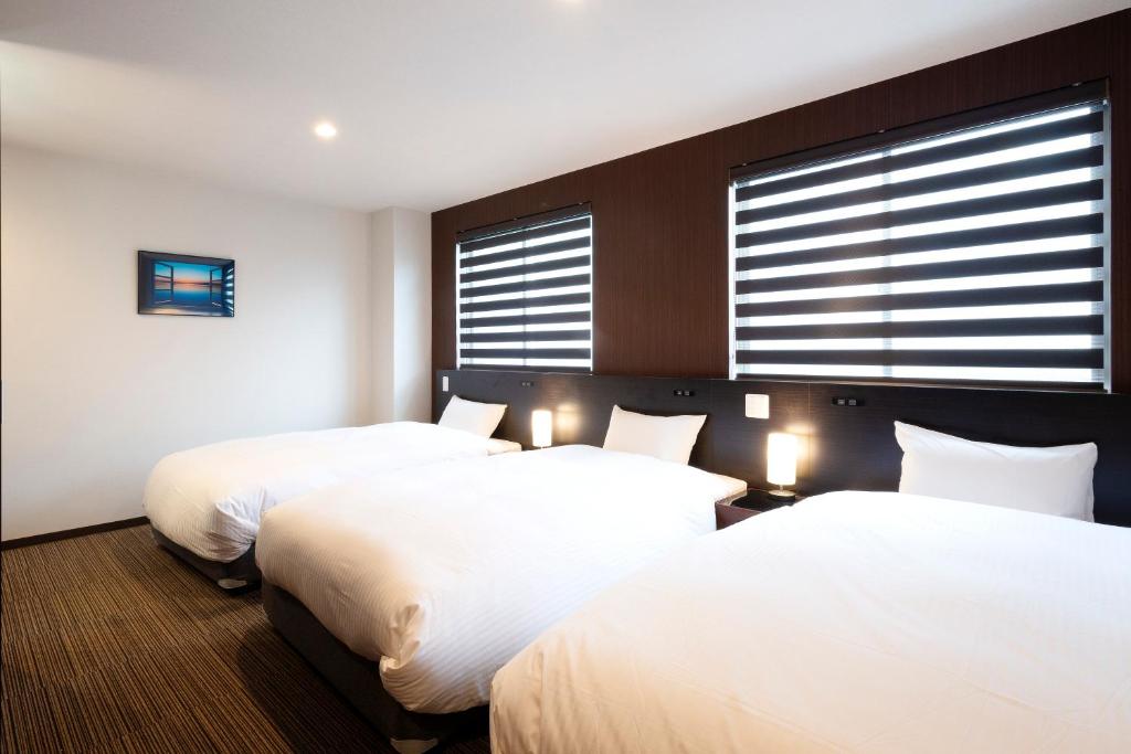 Postel nebo postele na pokoji v ubytování Hotel Kojan