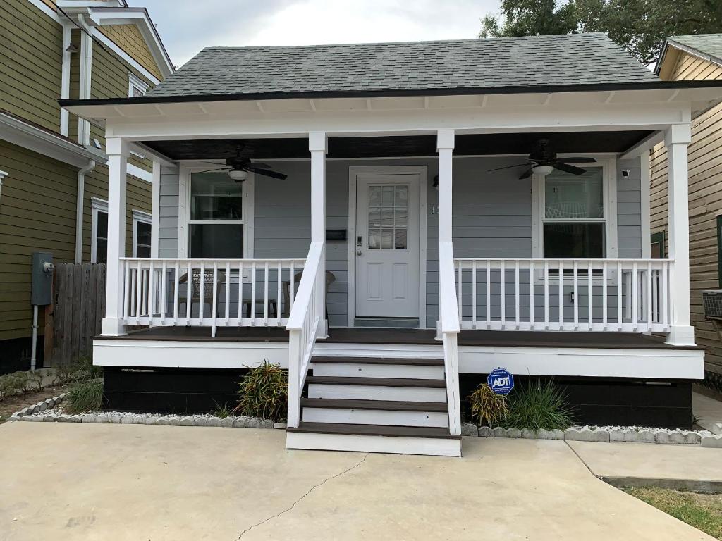 a house with a white porch with a white door at Peaceful Getaway for Two in Lincolnville/Quiet Area/2.3 Miles to Beach in St. Augustine