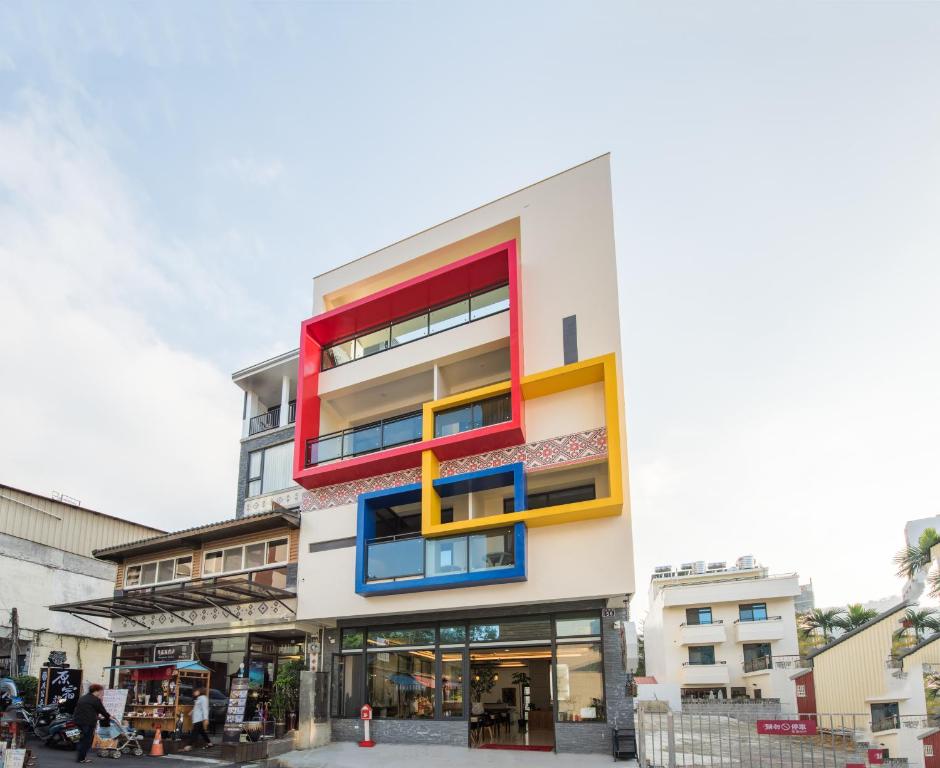 a building with colorful balconies on the side of it at 逐鹿森林民宿-無電梯 in Yuchi