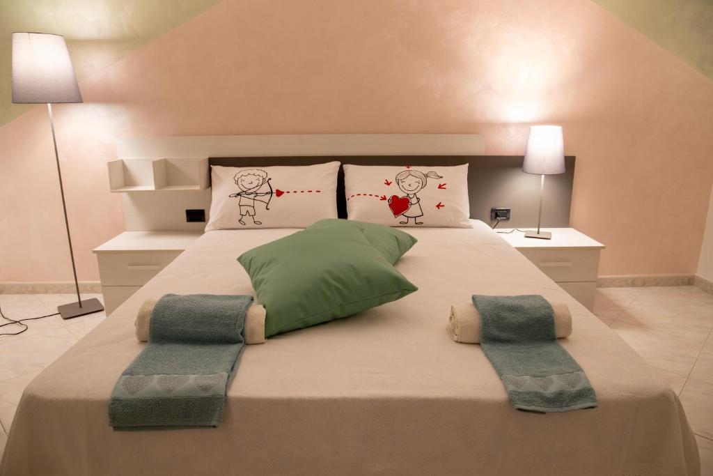 um quarto com uma cama grande e 2 almofadas em AriadiMare em Molfetta