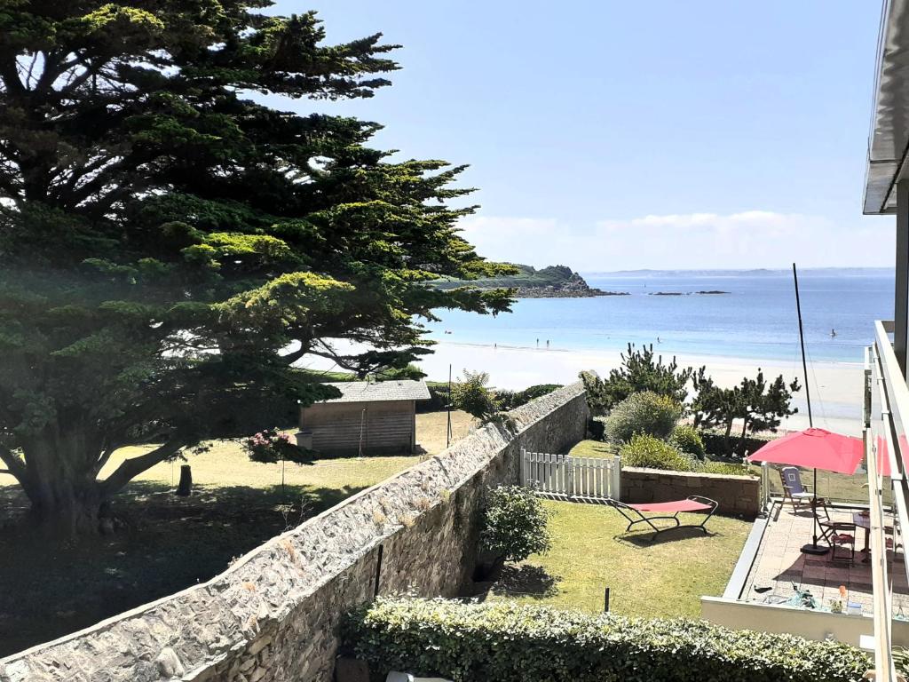 a retaining wall with a view of the ocean at Les pieds dans l eau accès à la plage depuis la résidence in Trébeurden