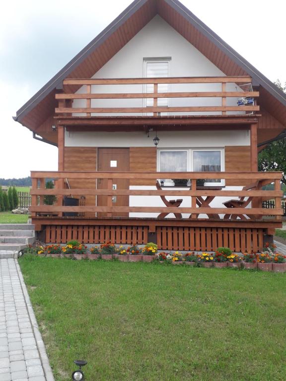 a house with a large deck on the side of it at Agroturystyka Domek u Barbary in Lesko