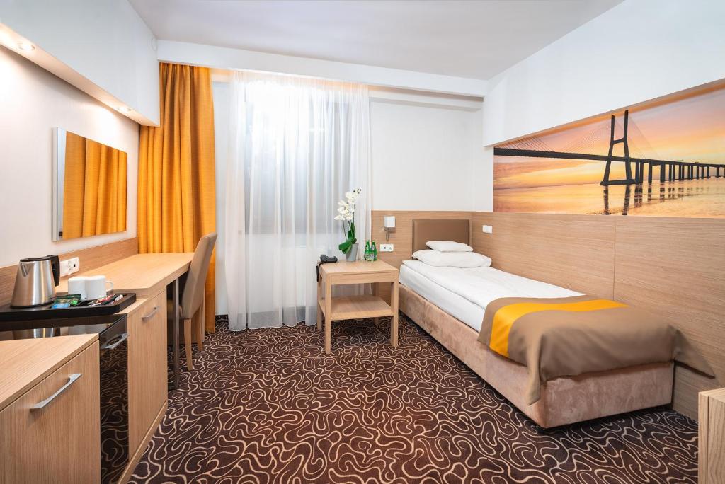 En eller flere senge i et værelse på Hotel Amazonka Conference and Spa