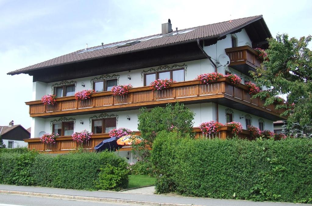 a house with flower boxes on the side of it at Pension Sonnenhof in Bischofsmais