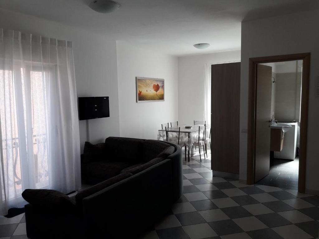 a living room with a couch and a table at La Casa dei Gelsi in Castel Gandolfo