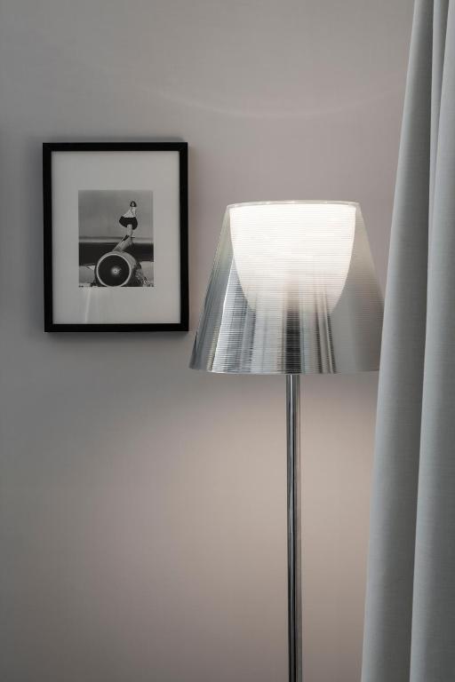 a lamp and a picture on a wall with a picture at La Suite Boutique Hotel in Procida