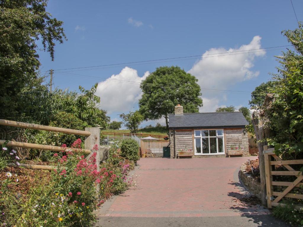 a cottage with a fence and a driveway at The Boundary Annex in Bishops Castle