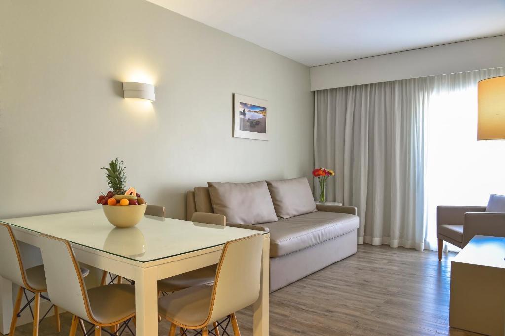 a living room with a table and a couch at Aqualuz Lagos by The Editory in Lagos