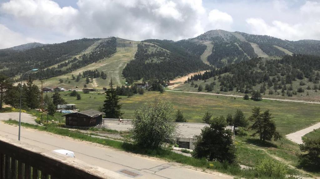 a view of a valley with a road and mountains at Gréolières les neiges in Gréolières