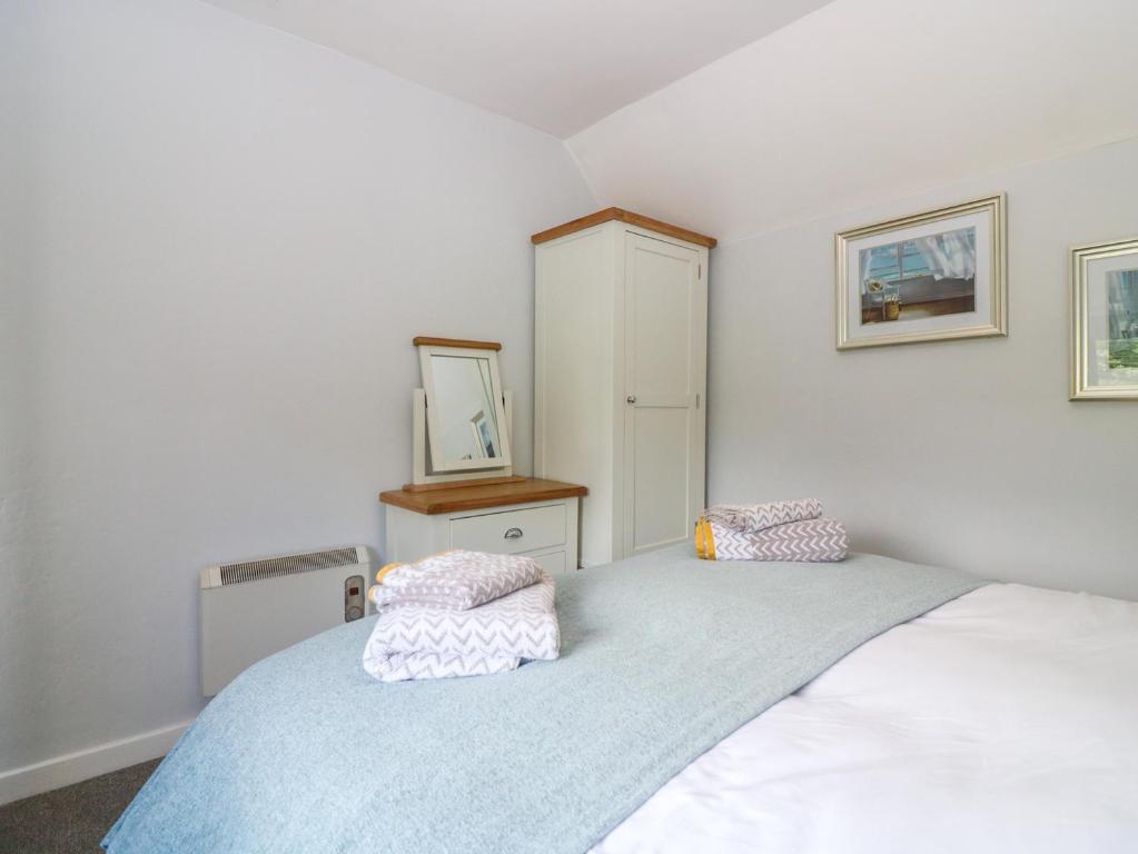 a bedroom with a bed with two pillows on it at 2 Tougal in Mallaig