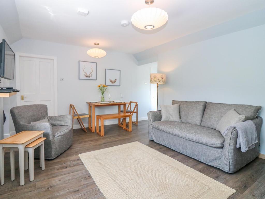 a living room with a couch and a table at 2 Tougal in Mallaig