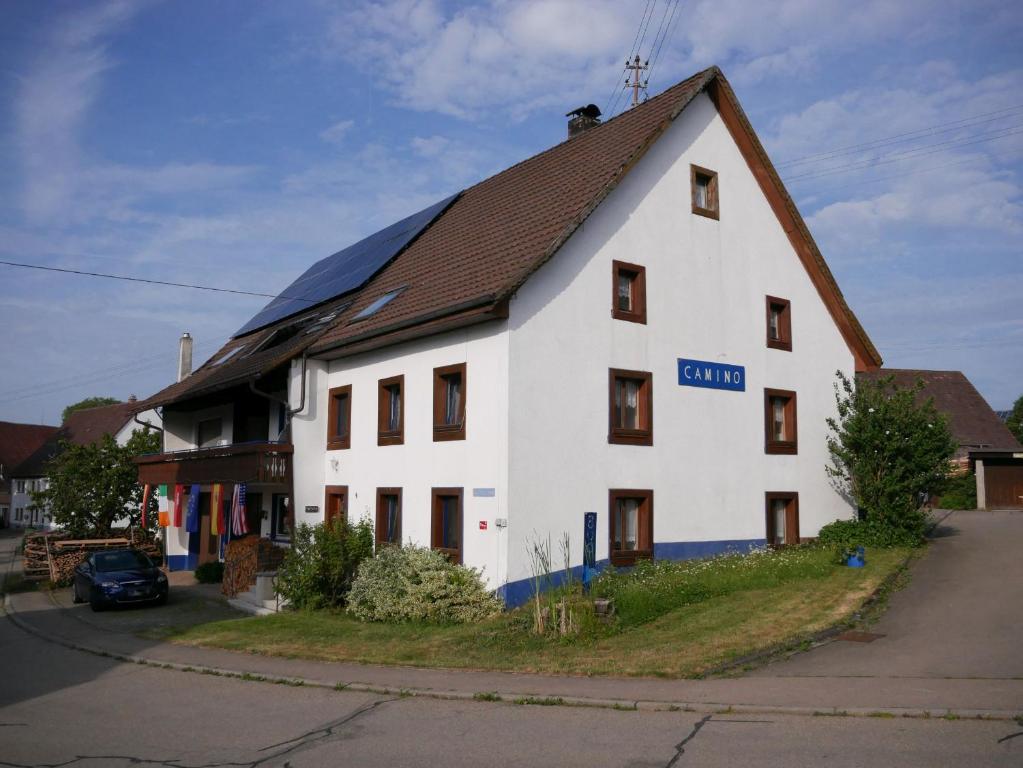 a large white building with a brown roof at Haus Camino in Löffingen