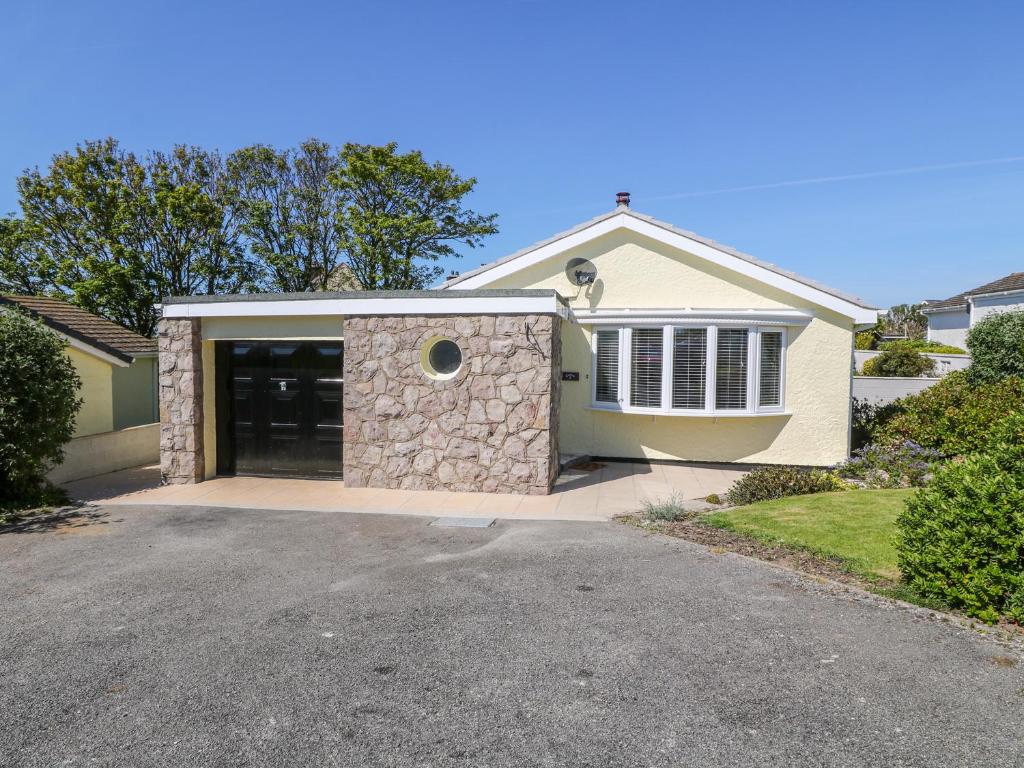 a house with a garage and a driveway at Croeso in Cemaes Bay