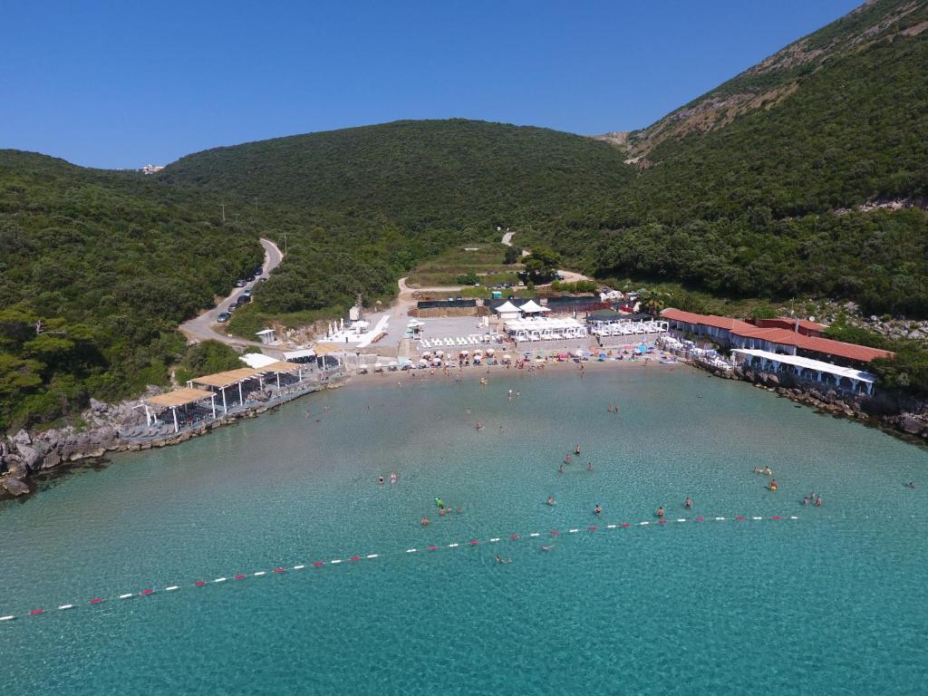 a group of people in the water at a beach at Trsteno Beach Apartments in Budva