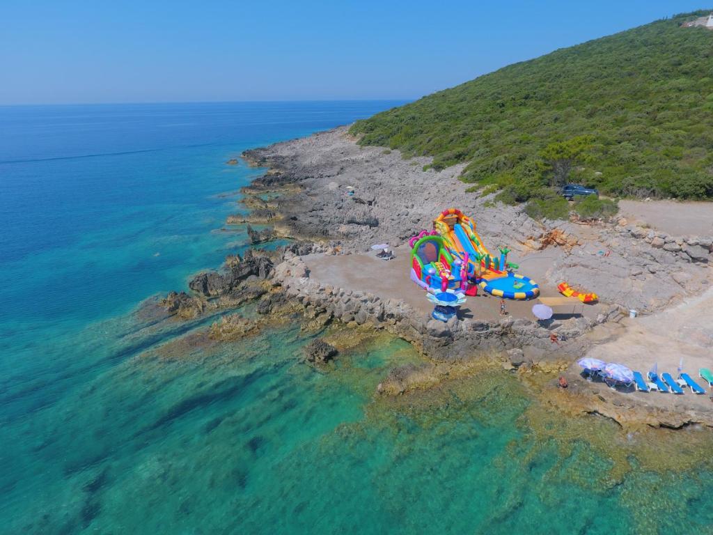 an aerial view of a beach with a water park at Trsteno Beach Apartments in Budva