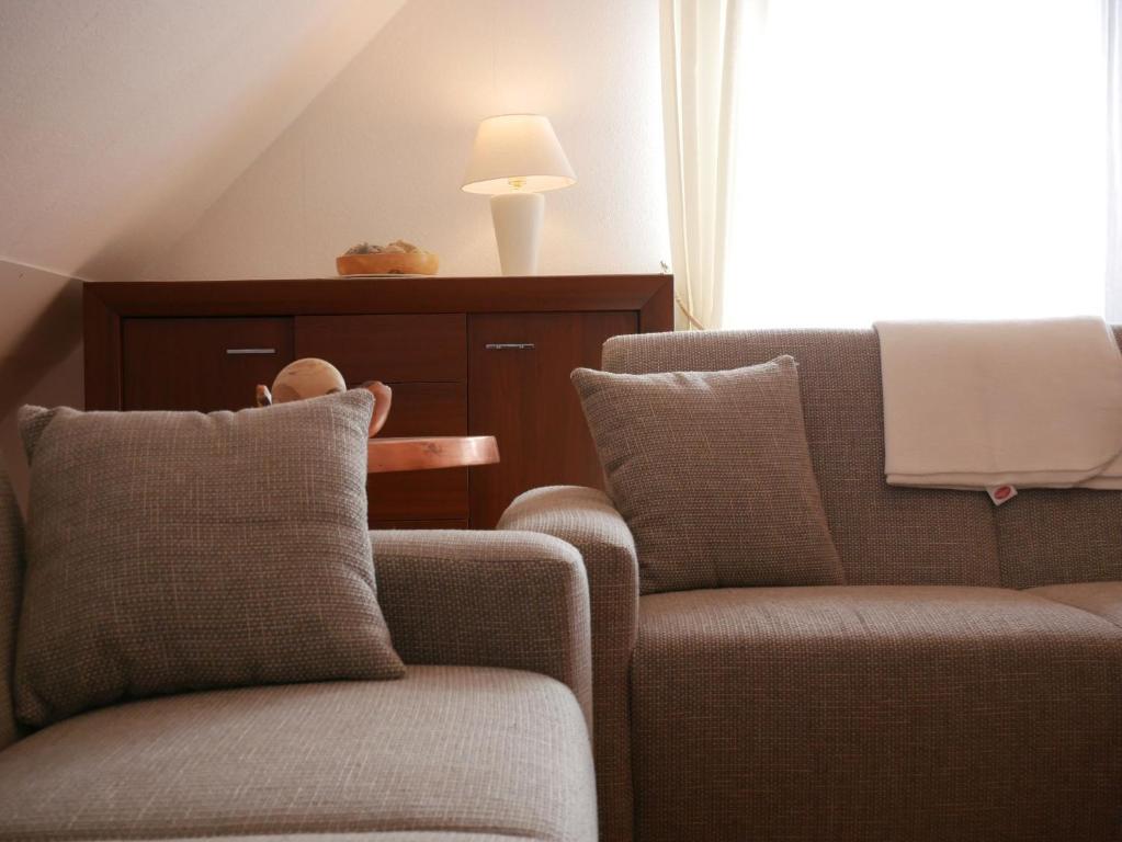 a living room with two chairs and a lamp at Haus Philipp in Bad Urach