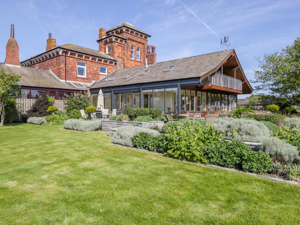 an exterior view of a house with a yard at Villa Marina in Barrow in Furness