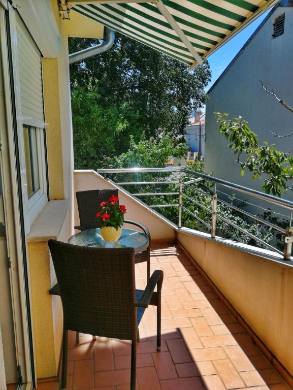 a patio with a table and chairs on a balcony at Jasmina in Senj