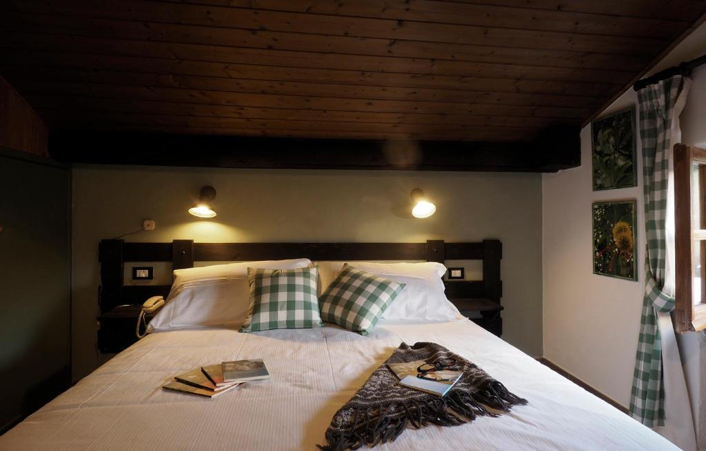 Postel nebo postele na pokoji v ubytování Locanda Il Rustichello