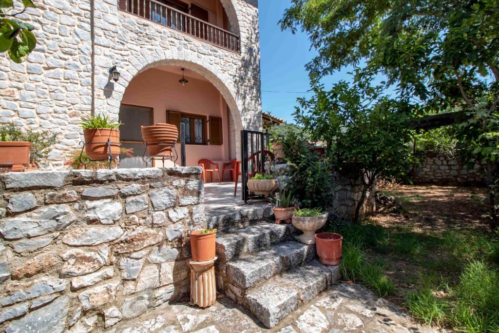 a stone house with stairs leading to a patio at Laconian Collection #Karvela's stone house# in Karvelás