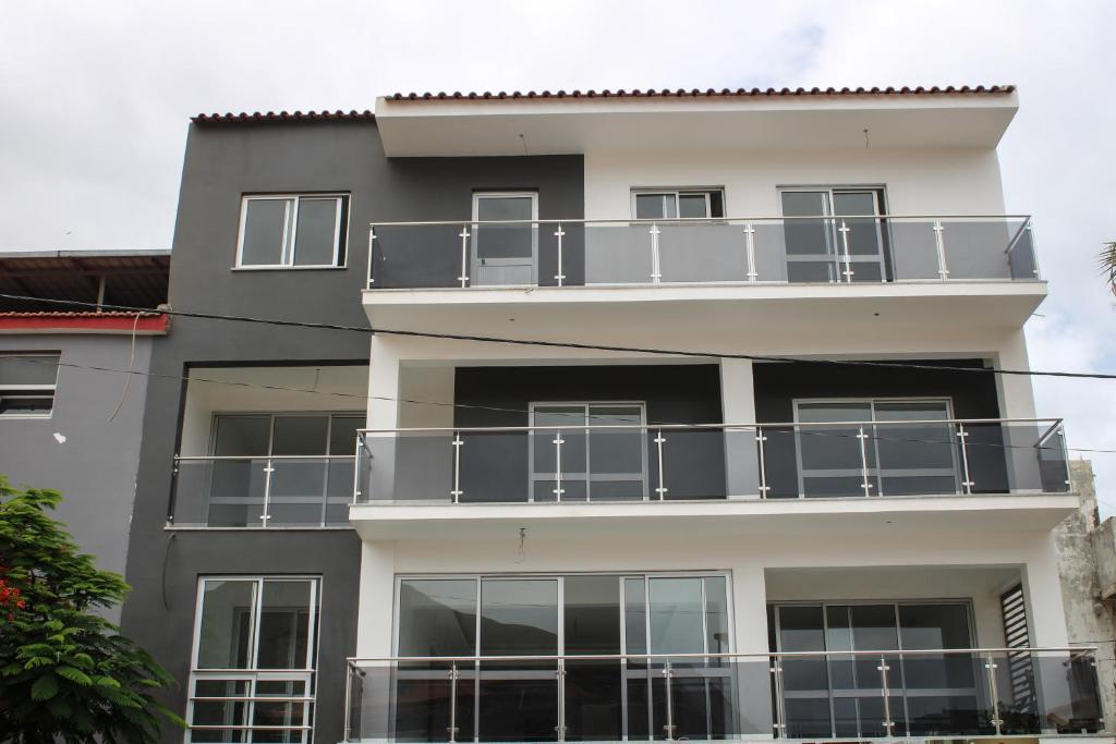 an apartment building with a balcony on it at Apartamentos DECOR in Tarrafal