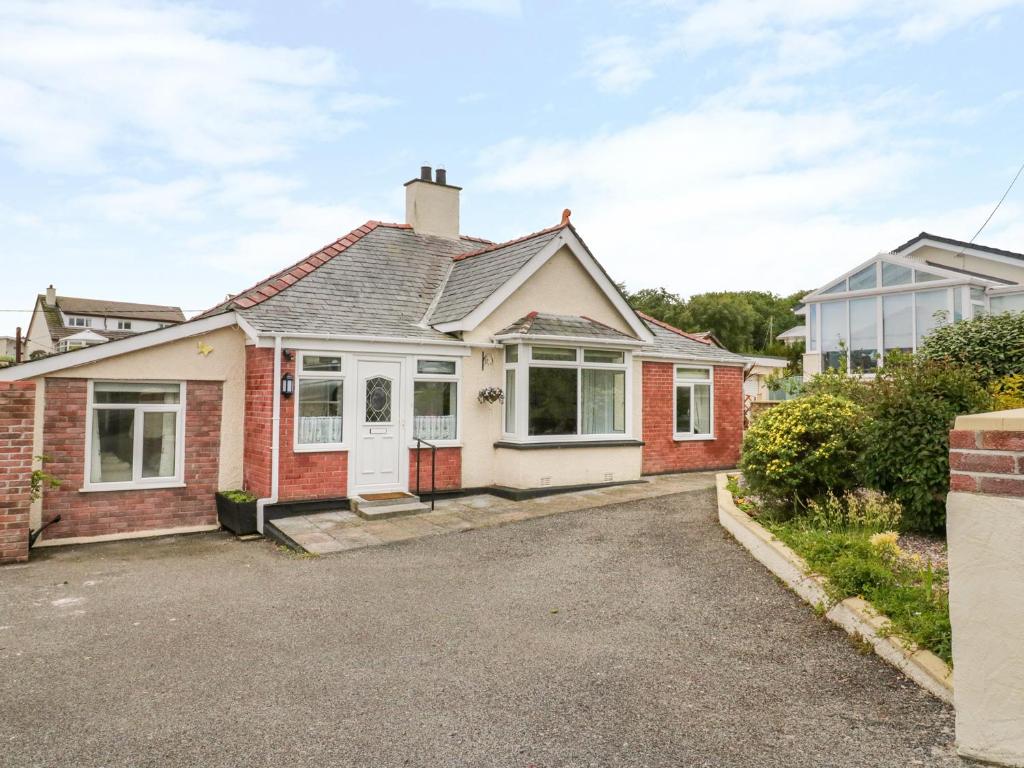 a house with a driveway in front of it at Stonyway in Benllech