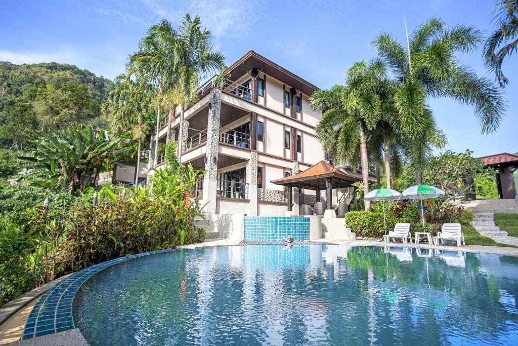 a house with a swimming pool in front of a house at Kamala Villa Hill in Kamala Beach