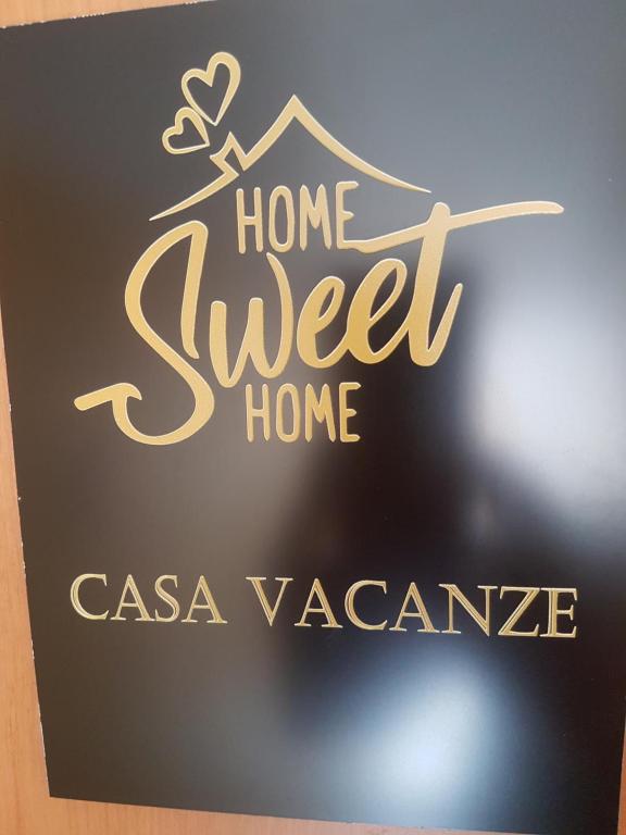 a sign that says home sweet home on a wall at Home Sweet Home COSENZA in Cosenza