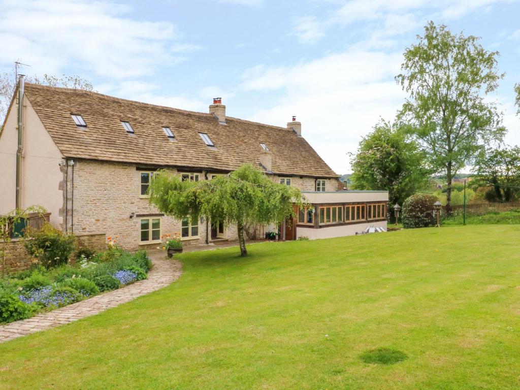 an exterior view of a house with a yard at Tickmorend Farm in Stroud