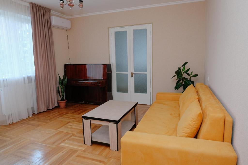 a living room with a couch and a table at Keti&Tatia Sisters Apartment - near Old and Central Tbilisi in Tbilisi City