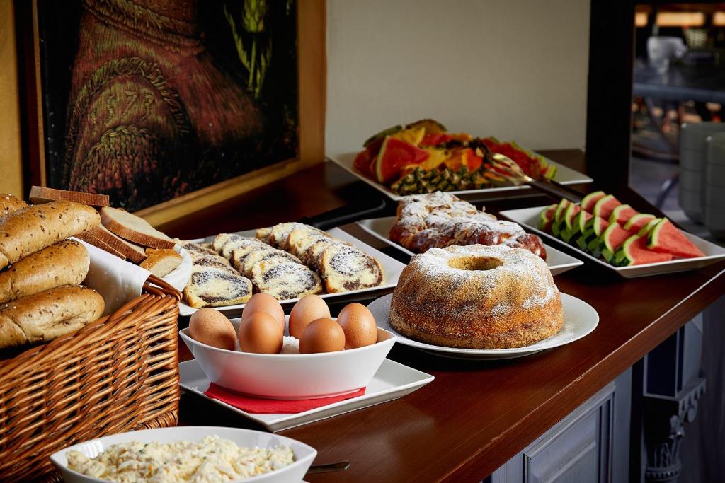 a buffet with different types of bread and pastries at Hotel U Kata in Kutná Hora