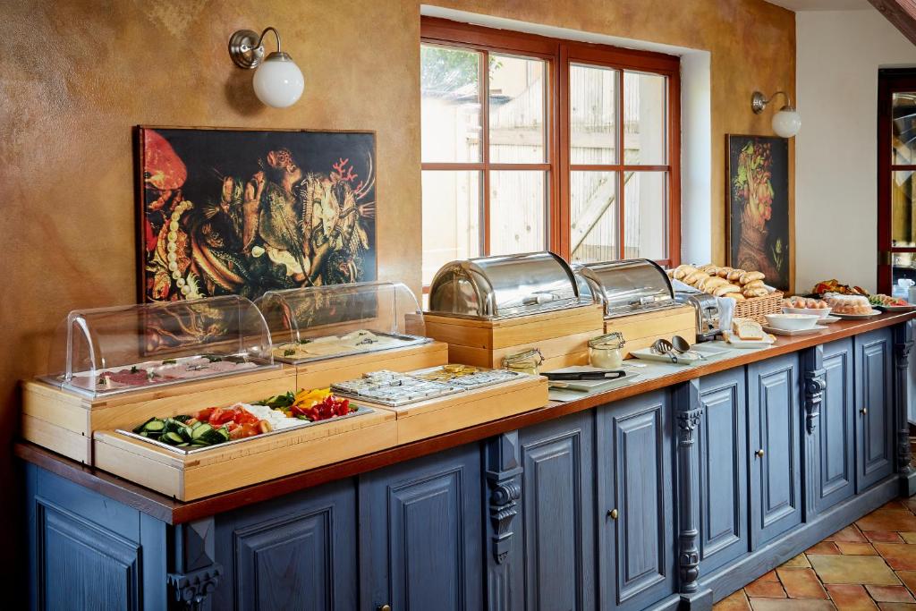 a buffet line with fruits and vegetables on display at Hotel U Kata in Kutná Hora