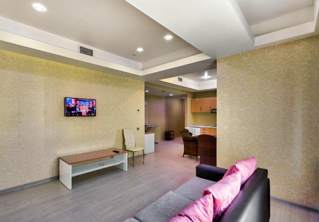 a living room with a couch and a table at Diplomat Suites in Baku