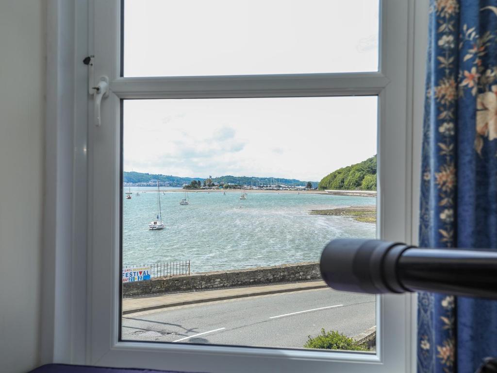 a window with a view of a body of water at Gadlys House - Waters Edge in Beaumaris