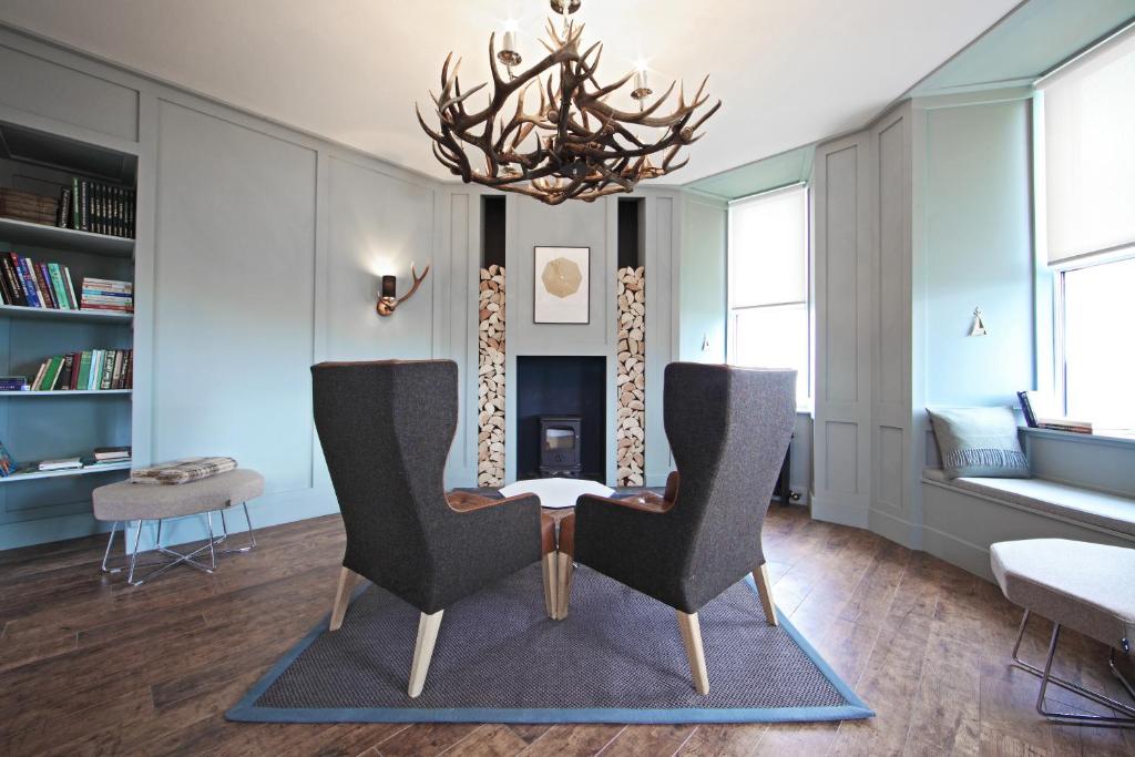 a living room with two chairs and a table at John O'Groats in John O Groats