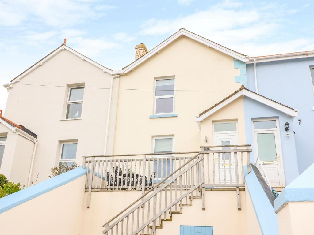 a house with stairs in front of it at Quayside View in Brixham