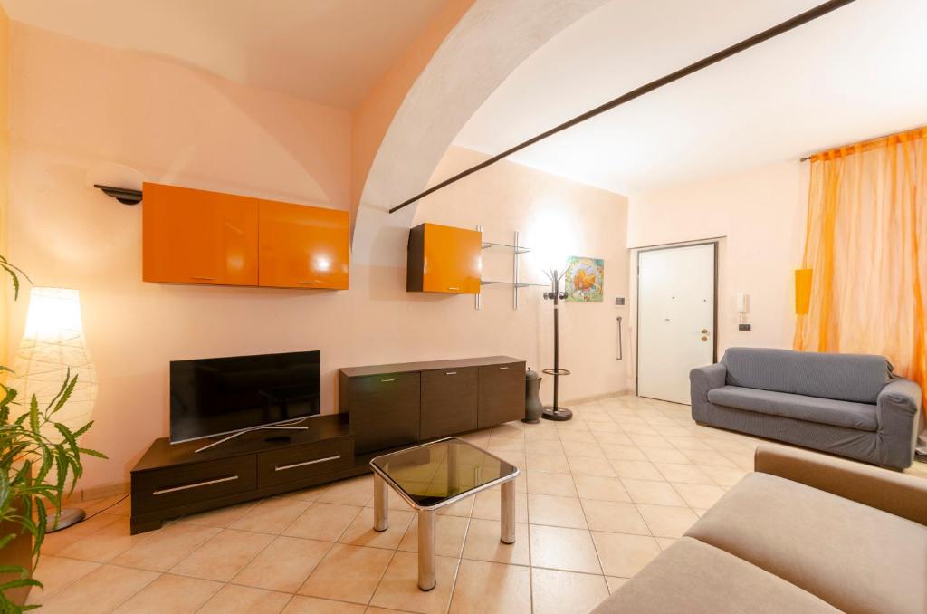 sala de estar con sofá y TV en JOIVY Warm Family Apt near Porto Antico, en Génova