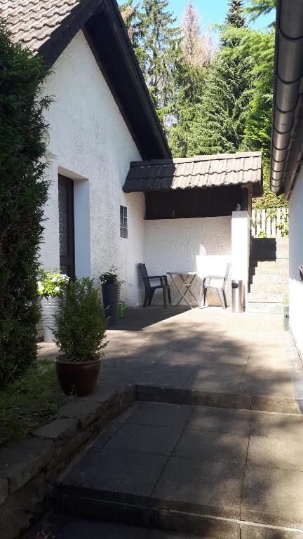 a patio with two chairs and a table in a house at Ferienwohnung Fuchs & Hase in Kronenburg