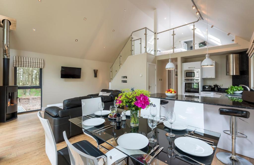 a kitchen and living room with a table and chairs at Bracken Howe Lodge in Whitby