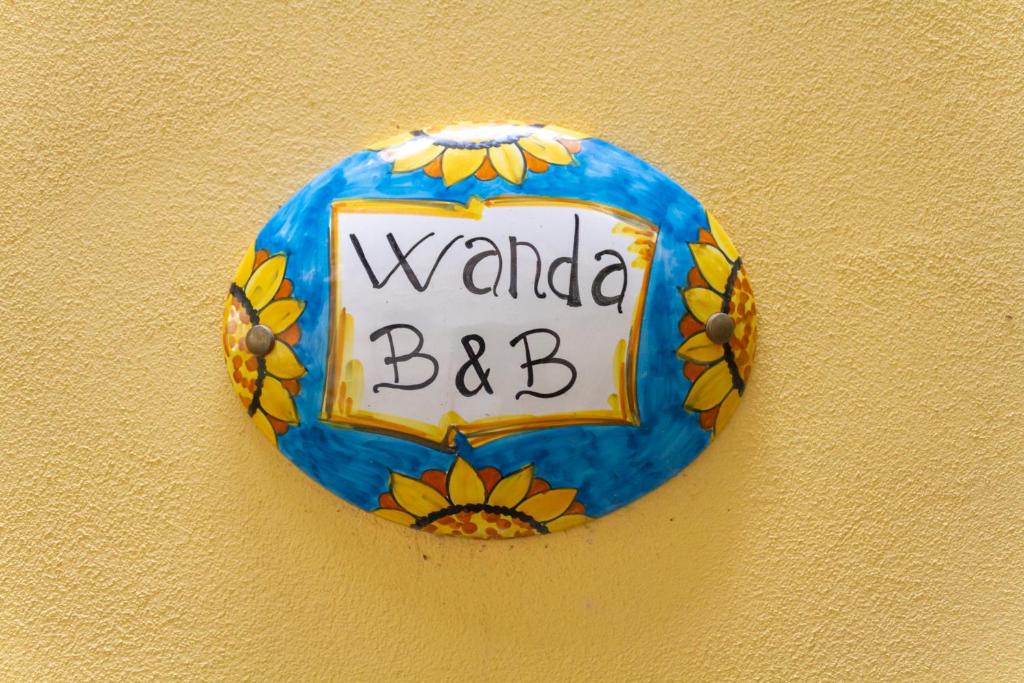 a sign on a wall with a wada bc on it at Wanda Bed&Breakfast in Naples