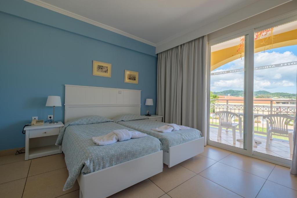 Postel nebo postele na pokoji v ubytování Hotel Athina