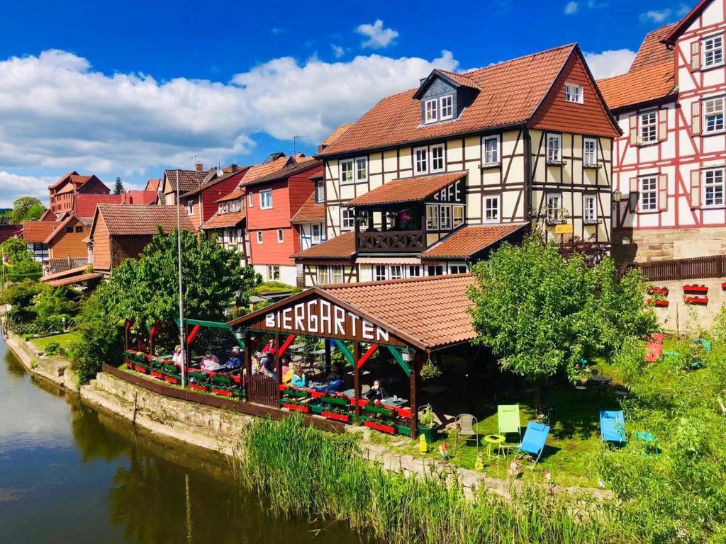 a group of buildings next to a river at Ferienhaus "Ahle Schinn" in Bad Sooden-Allendorf