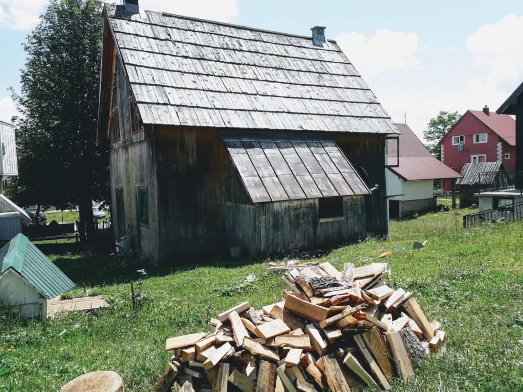 un montón de madera delante de un granero en Old Guest House 1964 en Žabljak