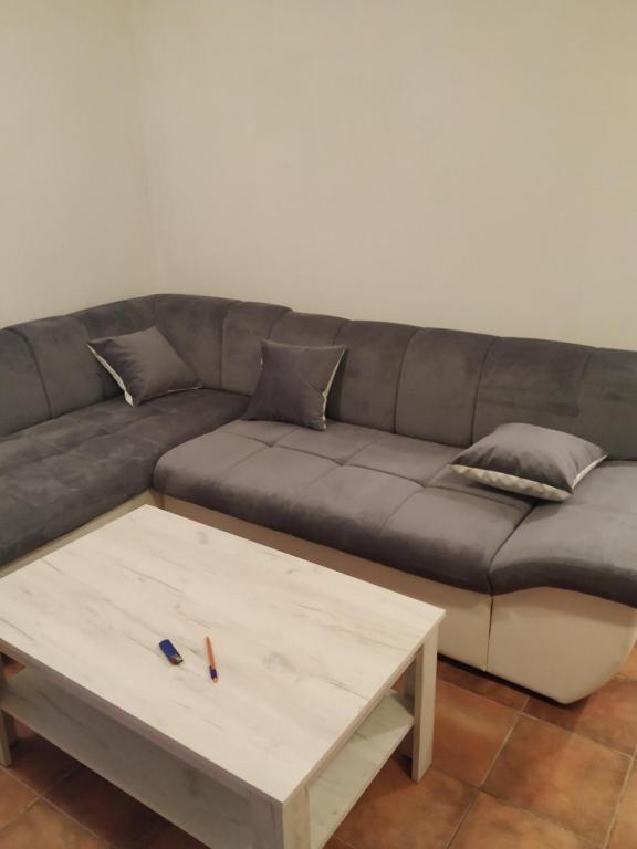 a living room with a couch and a coffee table at Apartmani Zelenika in Herceg-Novi