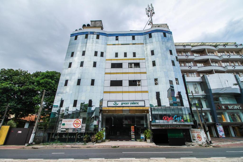 a tall white building on a city street at Green Palace Colombo in Colombo