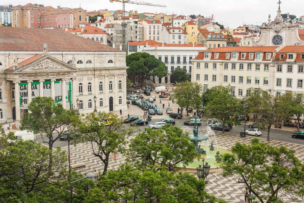 a view of a city with buildings and trees at Rossio Hostel in Lisbon